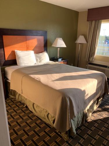 a bedroom with a large bed in a room at Relax Inn Heth in Shell Lake