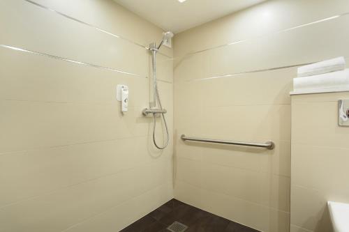 a bathroom with a shower stall and a toilet at Hotel Apolonia Paris Mouffetard, Sure Hotel Collection by Best Western in Paris