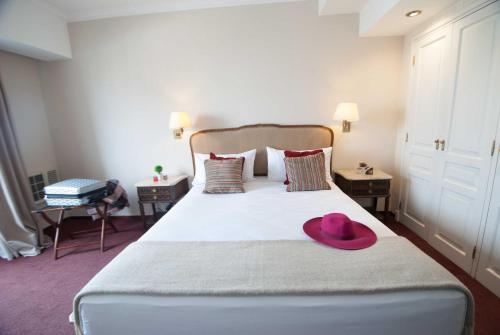 a bedroom with a bed with a pink hat on it at Ramada by Wyndham Buenos Aires Centro in Buenos Aires