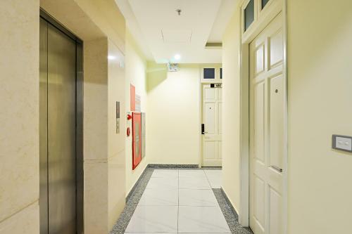 a hallway with a door and a tile floor at Suji My Dinh Hotel in Hanoi
