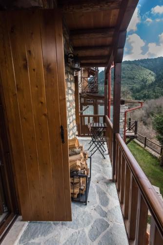 a door on a balcony with a view of the mountains at Μαγεμένο Βουνό in Karpenision