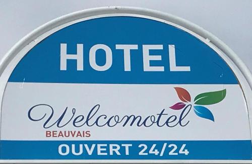a sign for a hotel with a welcome sign at Welcomotel Beauvais Aéroport in Beauvais