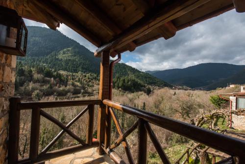a view from the balcony of a house with mountains in the background at Μαγεμένο Βουνό in Karpenision