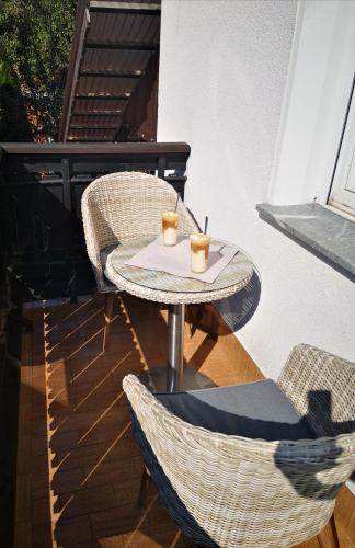 a small table with two drinks on a patio at Apartment Andy in Medvode