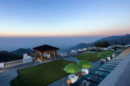 an aerial view of a resort with tables and umbrellas at Jaypee Residency Manor in Mussoorie