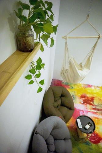 a room with a plant and a hammock on a wall at QBE B&B in Nanwan