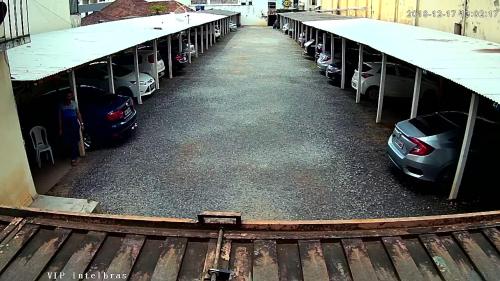a parking lot with cars parked in it at Presidente Hotel in Passos