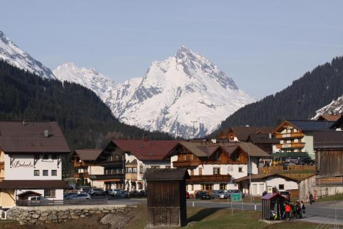 a snow covered mountain in the background of a town at Ferienwohnungen Sonderegger in Ischgl
