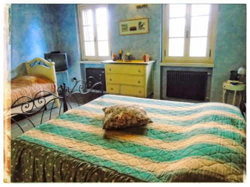 a bedroom with two beds and a dresser and windows at Casa Vacanze SoleLuna in Montichiari