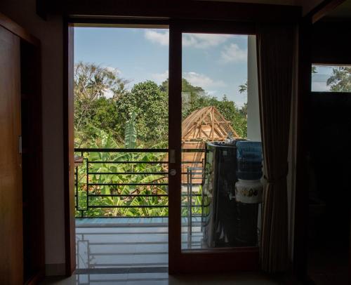 an open door with a view of a house at Ratna Villa 4 in Ubud