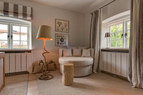 a living room with a chair and a lamp at Weissenhaus Private Nature Luxury Resort in Weißenhaus