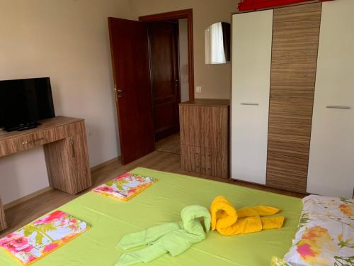 a bedroom with a bed with towels on it at Jacky's Apartament - Апартамент в Свети Влас in Sveti Vlas