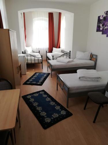 a living room with two beds and a couch at Pension Feldschlössl in Ingolstadt