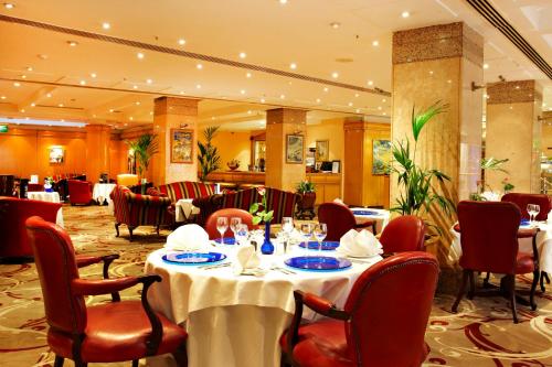 a dining room with a table and chairs and tablesktop at Washington Mayfair Hotel in London