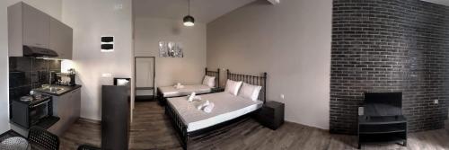 a room with a bed and a brick wall at Meteora House- Cozy Living in Kalabaka