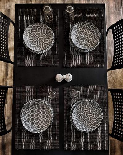 a table with four dining tables and two chairs at Meteora House- Cozy Living in Kalabaka