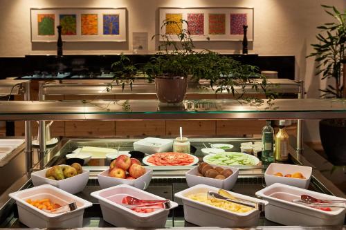 a buffet line with many different types of food at ERMITAGE Wellness- & Spa-Hotel in Gstaad