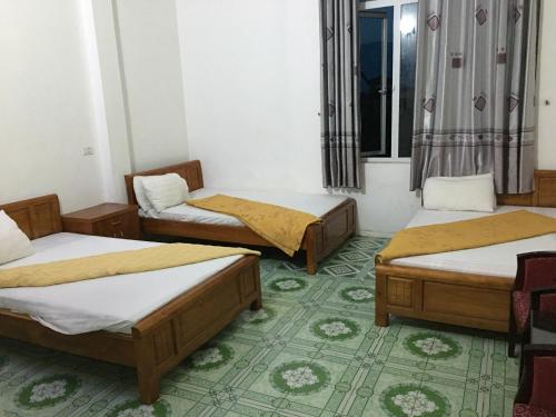 a group of three beds in a room at Nhà nghỉ Hòa Yến 1 in Yên Bái