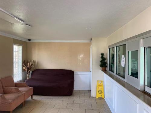 a living room with a couch and a chair at Texas Inn Beaumont in Beaumont