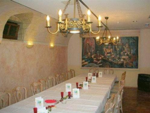 a dining room with a long table and a chandelier at Abakus-Hotel in Sindelfingen