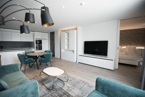 a living room with a couch and a table at Acropolis - Luxury Appartments I Hotelservice and FREE parking in Middelkerke