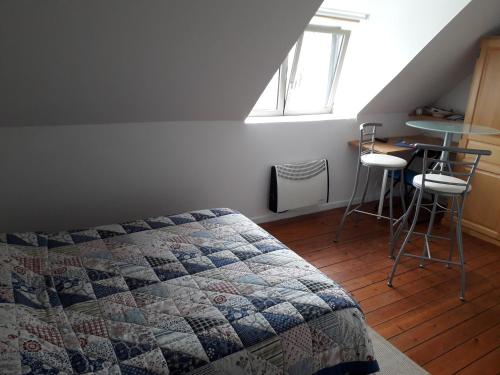une chambre avec un lit, une table et des chaises dans l'établissement VERYAC'H, à Camaret-sur-Mer