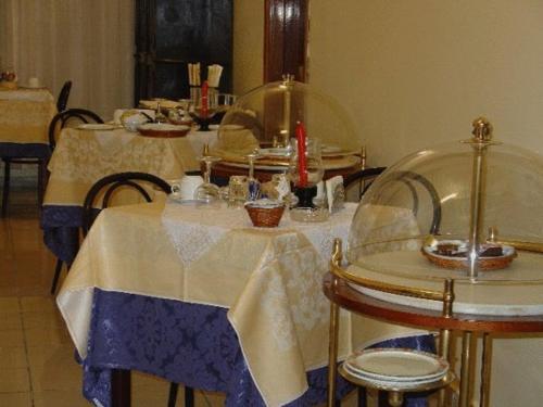 a table with a blue and white table cloth at Hotel Elefante Bianco in Crespellano