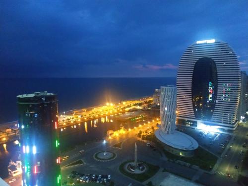 a view of a city at night with buildings at Batumi Orbi Apartments in Batumi