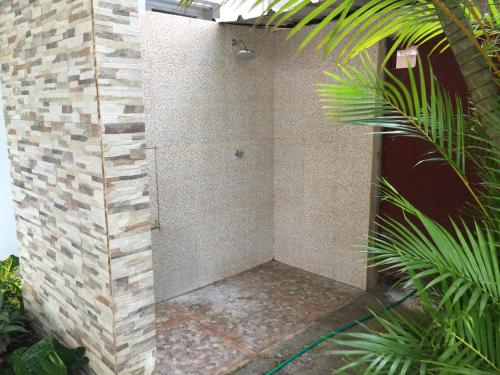 a shower in the side of a brick building at Hotel Alicia Beach in Sosúa