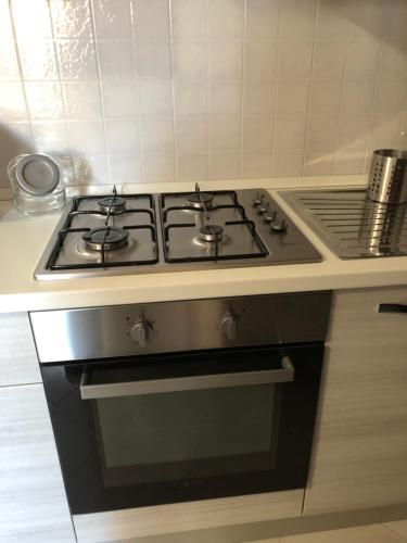a stove top oven in a kitchen next to a counter at Le case di Nonna Gina in Capranica