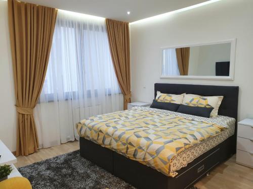 a bedroom with a bed and a large window at Belgrade Waterfront-Delux apartman Beograd na vodi in Belgrade