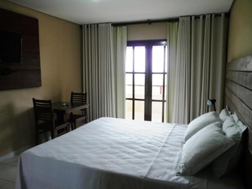 Ein Bett oder Betten in einem Zimmer der Unterkunft Pousada Calugi