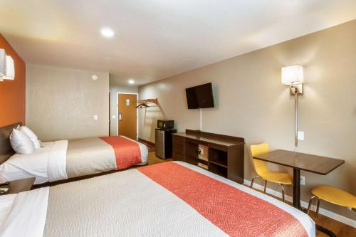 a hotel room with two beds and a desk at Motel 6-Rossford, OH in Rossford