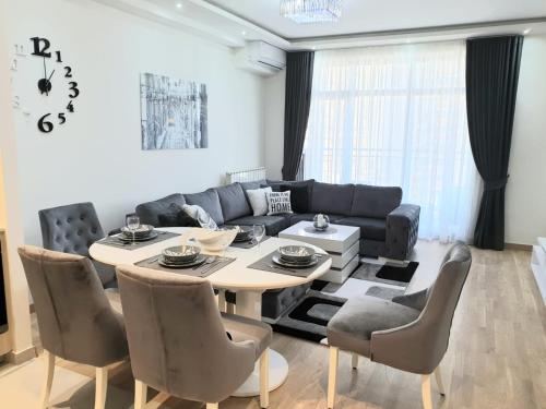 a living room with a table and a couch at Belgrade Waterfront-Delux apartman Beograd na vodi in Belgrade