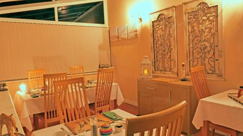 a dining room with two tables and chairs at Marmalade Bed & Breakfast in Torquay