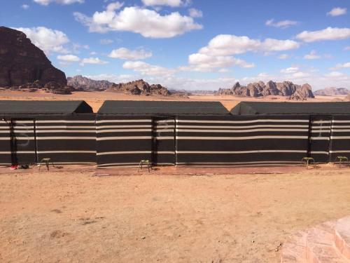 a black and white fence in the desert at WADI RUM-Bedouin Tents and Jeep Tours in Wadi Rum