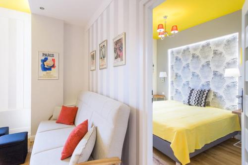 a small bedroom with a bed and a couch at Apartament przy Parku Krakowskim in Kraków