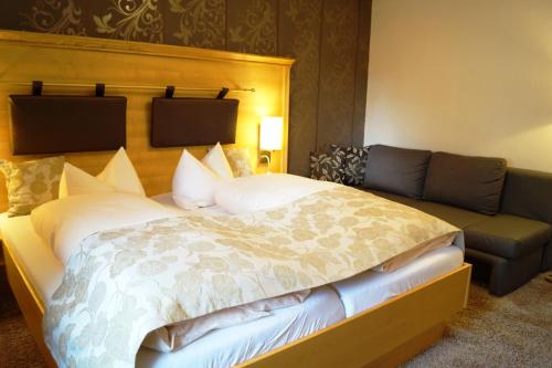 a bedroom with a large bed and a couch at Engemann Kurve in Winterberg