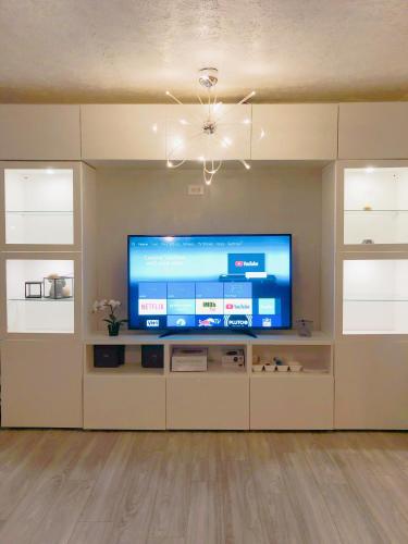 a living room with a large flat screen tv at 2 Bedrooms Robinwood Condo in Norcross