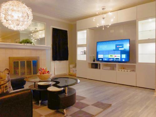 a living room with a large screen tv and a couch at 2 Bedrooms Robinwood Condo in Norcross