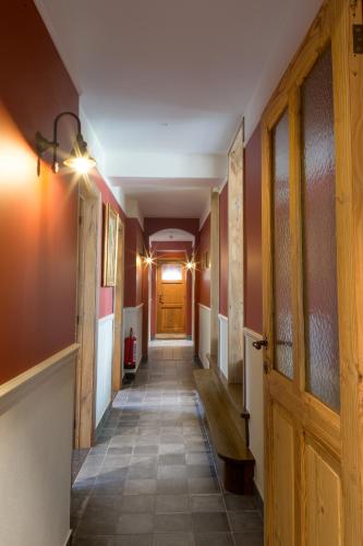 ein langer Flur mit einer Holztür und einem Flur sidx sidx in der Unterkunft Cottage de Vinck in Ypern