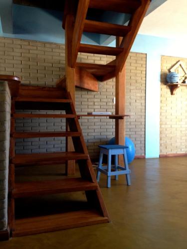 a room with a bunk bed and a blue stool at Casa Blanka 2010 - Eco Surf Guest House in Itacaré