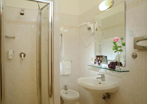 a bathroom with a shower and a sink and a mirror at Best Western Hotel Rome Airport in Fiumicino