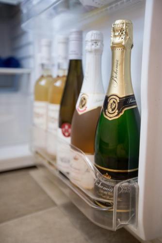 a refrigerator filled with lots of bottles of champagne at FAMILY Apartment OSTRAVA in Ostrava