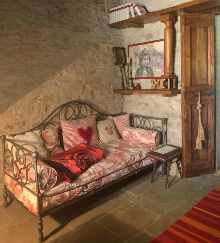 a couch with pillows on it in a room at Ca' Maranghi Holiday House in Palazzuolo sul Senio