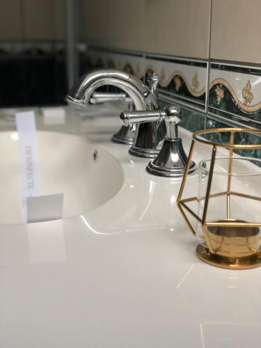 a bathroom sink with a chrome faucet at Vila De Argint Aleea Pelesului Nr 2 in Sinaia