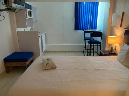 a hotel room with a bed with a bag on it at Hotel H Montreal in Guadalajara