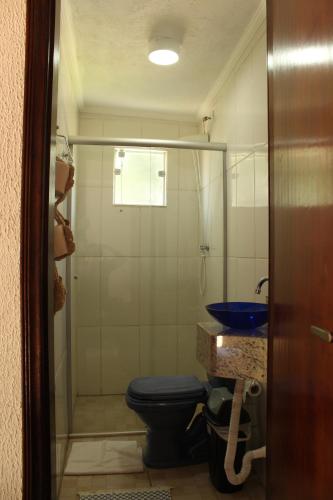 a bathroom with a blue toilet and a sink at Guappo Socorro in Socorro