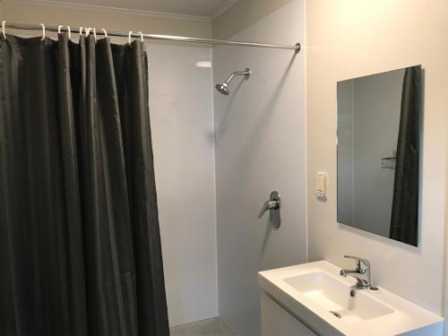 a bathroom with a shower curtain and a sink at Twizel Holiday Park in Twizel