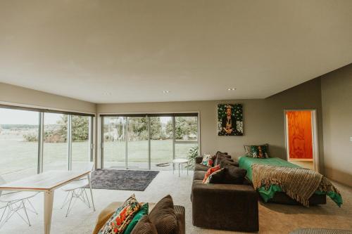 a living room with a couch and a table at Appleby House & Rabbit Island Huts in Mapua
